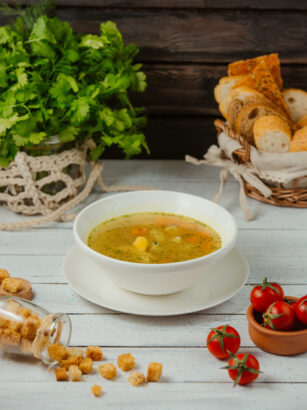 a-bowl-of-chicken-soup-with-potato-carrot-and-dill-served-with-bread-slices