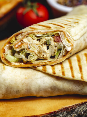 side-view-chicken-roll-grilled-chicken-lettuce-cucumber-tomato-and-mayo-in-pita